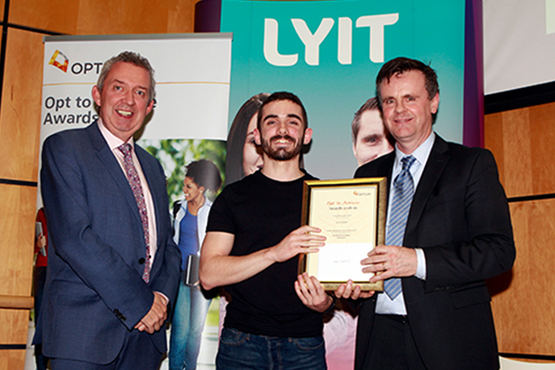LYIT student holding a financial reward with Optum Ireland & UK Managing Director Padraig Monaghan